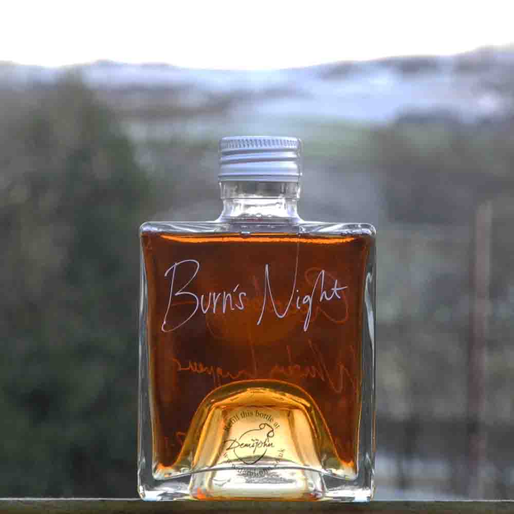 A 500ml refillable cube bottle of Gooseberry Whisky Liqueur from Moffat with handwritten personalised bottle message: Burns Night